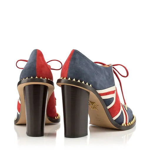 Back view of Charlotte Olympia Union Jack Lace-Up Ankle Boots, featuring lizard-effect embossed calfskin, floral detailing, and punk-inspired stud embellishments. The bold block heel adds height and a striking silhouette to this luxury statement piece.