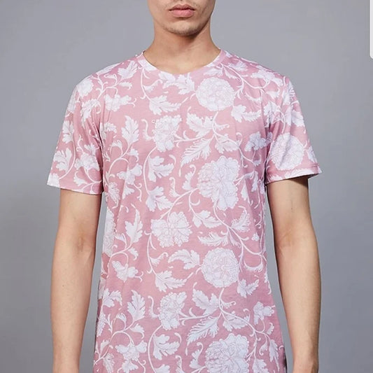 A man wearing the Criminal Damage Richmond T-Shirt in blush pink with an allover white floral print. The raised "Criminal Damage" branding is prominently displayed on the chest, showcasing its trendy and casual design.