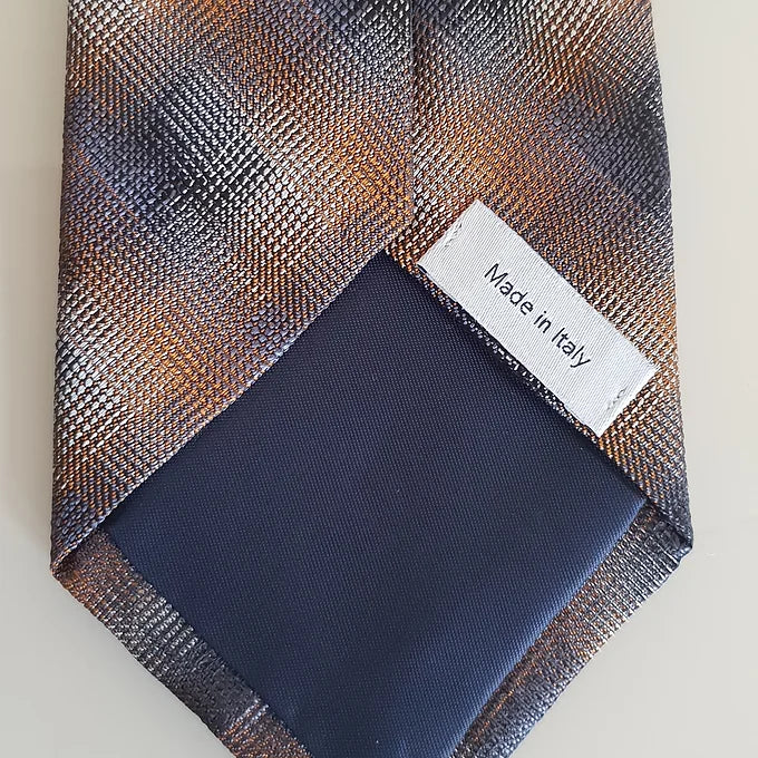 A close-up of the back of the Duchamp Abstract Check Tie, showing the inside material and the “Made in Italy” label. The image emphasizes the quality craftsmanship and premium silk fabric.