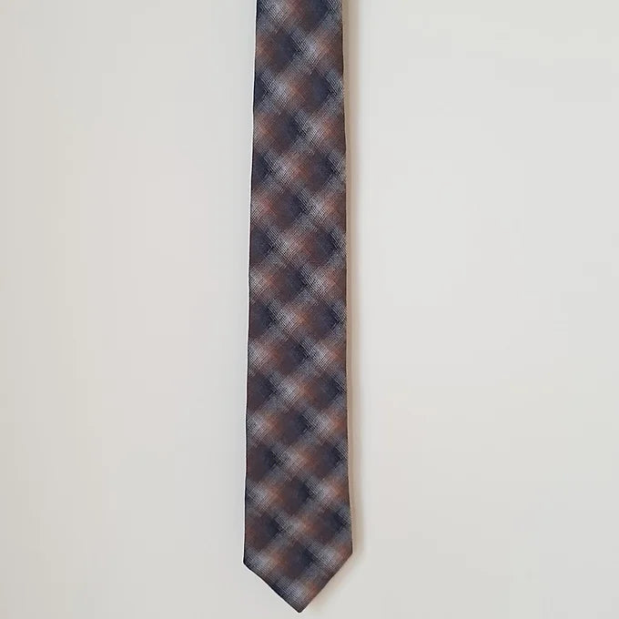 A half-length view of the Duchamp Abstract Check Tie, focusing on the wide end with its striking abstract check design. The luxurious silk material and elegant craftsmanship are prominently displayed.