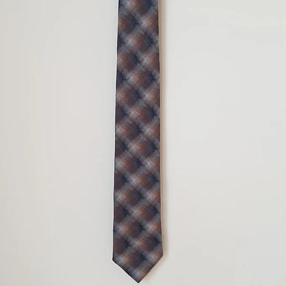 A half-length view of the Duchamp Abstract Check Tie, focusing on the wide end with its striking abstract check design. The luxurious silk material and elegant craftsmanship are prominently displayed.