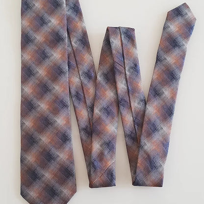 A full-length view of the Duchamp Abstract Check Tie arranged in a zigzag or folded “W” shape. This display highlights the tie’s sleek design, vibrant autumnal tones, and premium silk construction.