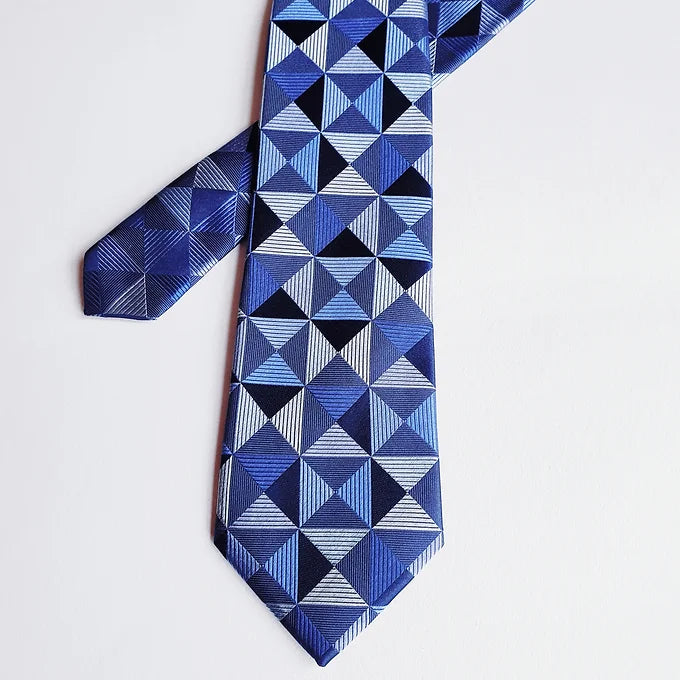 Duchamp London Blue Geometric Silk Tie arranged with the wide and narrow tips overlapping in a unique and stylish way, emphasizing the modern geometric pattern.