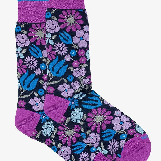 Pair of Duchamp London Botanical Floral Socks in purple, shown from a bird’s eye view. One sock partially overlaps the other, highlighting the intricate floral pattern along with contrast heel and toe details.